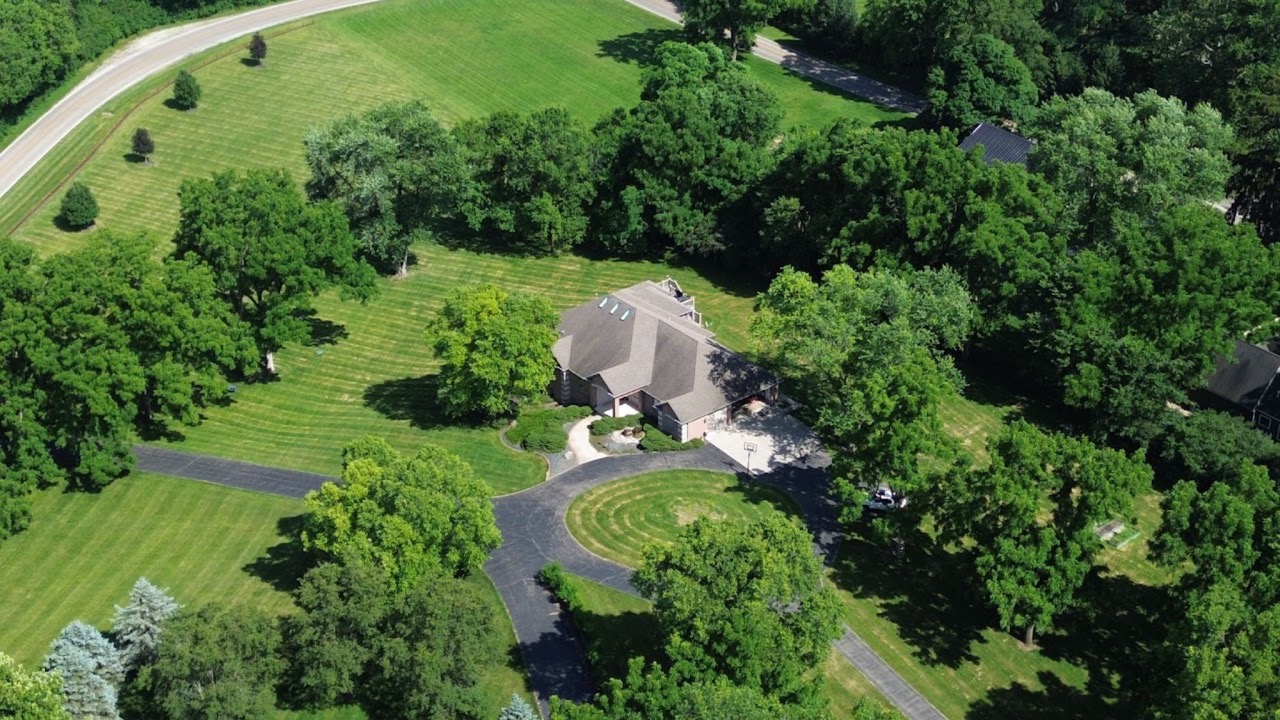 Aerial view of a home on a large wooded lot